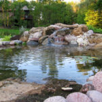 Gallery image of a landscaped backyard pond with waterfall feature